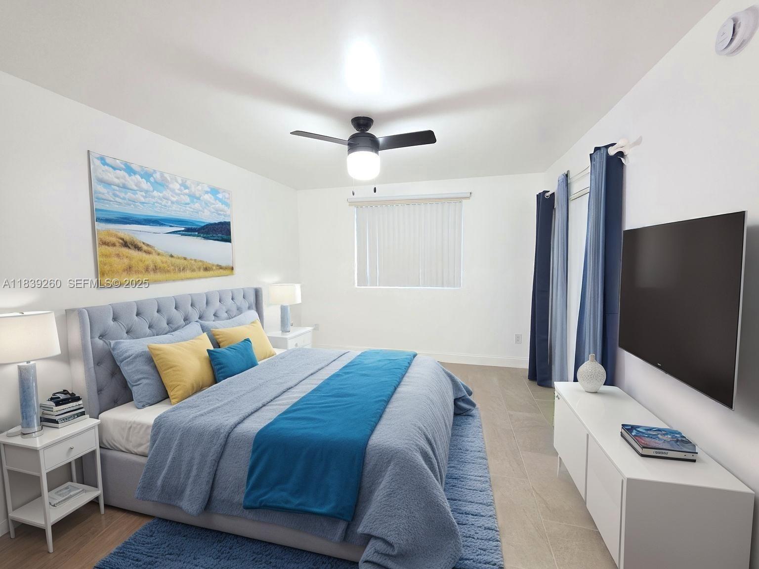 2620 South University Drive, Unit 111 Davie, FL 33328 - Photo 26 of 49 a bedroom with bed and a flat screen tv