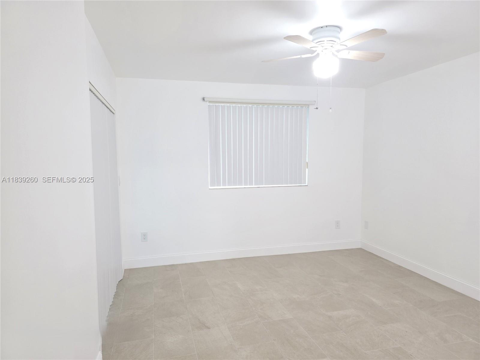 2620 South University Drive, Unit 111 Davie, FL 33328 - Photo 29 of 49 an empty room with a window and a ceiling fan