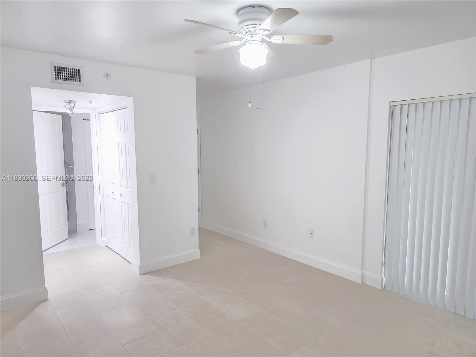 2620 South University Drive, Unit 111 Davie, FL 33328 - Photo 30 of 49 an empty room with a fan & a ceiling fan