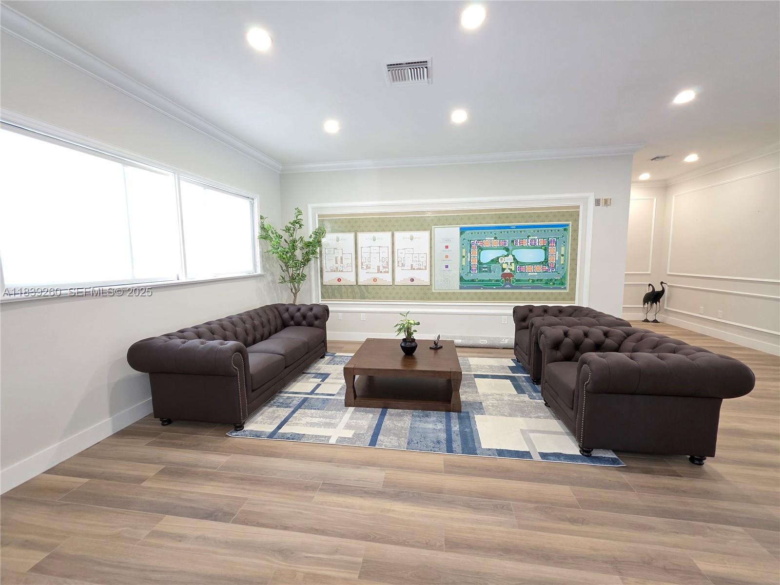 2620 South University Drive, Unit 111 Davie, FL 33328 - Photo 36 of 49 a living room with furniture a large window and a wooden floor