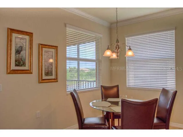 a view of a dining room with furniture and window