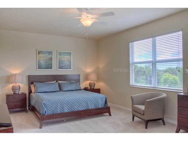 a bedroom with a bed and a couch