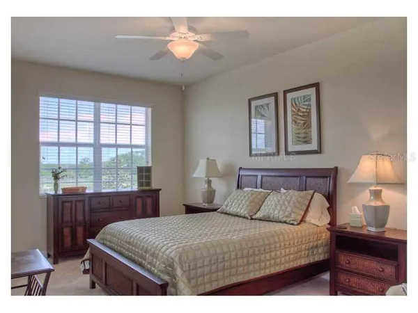 a bedroom with a bed and a night stand