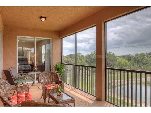 a balcony with chairs and table