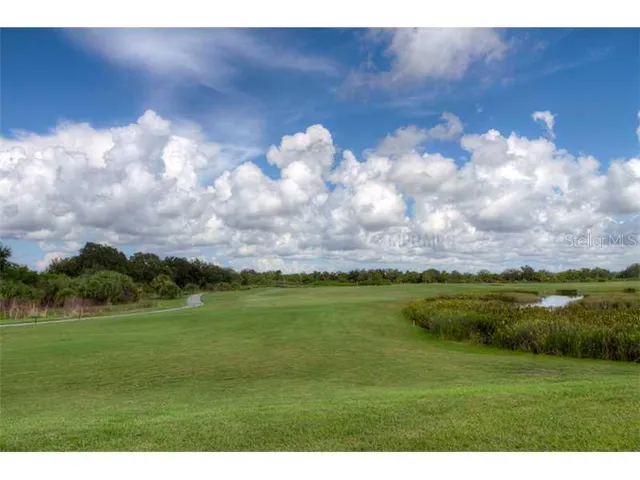 a view of a golf course with a lake