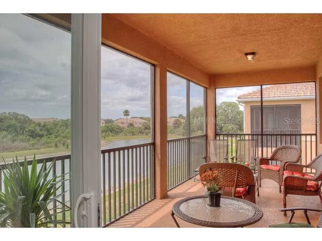 a view of a porch with furniture and wooden floor