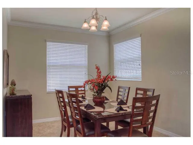 a dining room with furniture and window