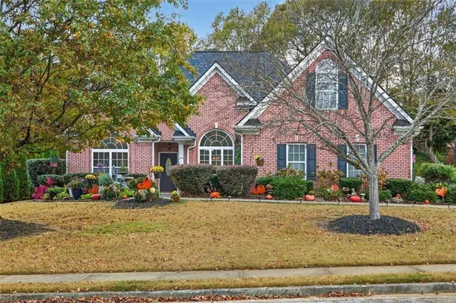 a front view of a house with a yard