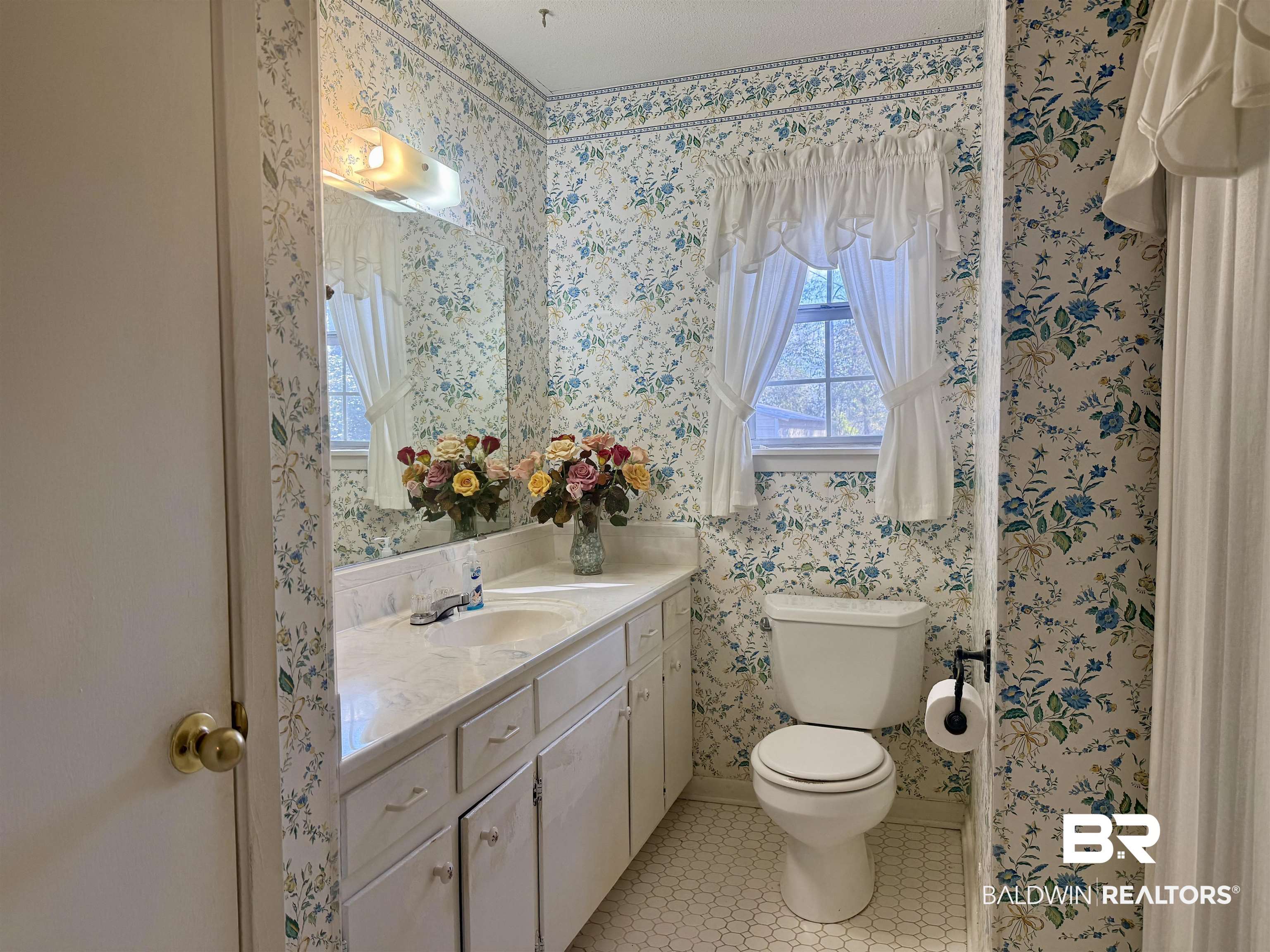 215 Young Street Brewton, AL 36426 - Photo 11 of 25 Bathroom with vanity, light tile patterned flooring, and wallpapered walls