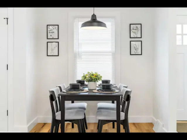 a dining room with furniture and window