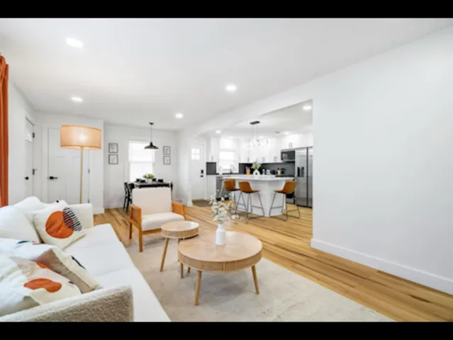 a living room with furniture and kitchen view