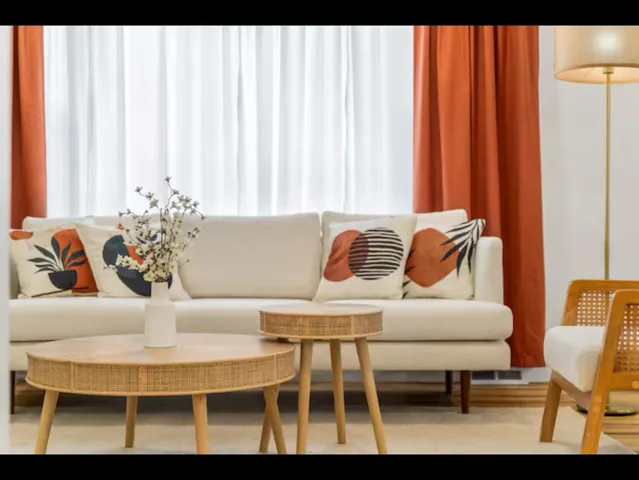 a dining room with furniture and a potted plant