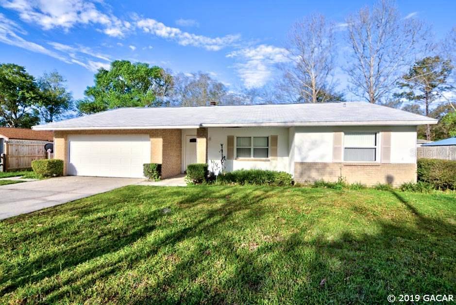 1202 Southwest 75th Drive Gainesville, FL 32607 - Photo 1 of 1 a view of a house with yard and plants