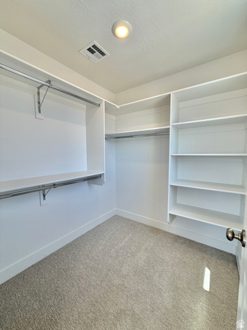 915 West Gold Ridge Ln Street St. George, UT 84790 - Photo 15 of 30 Spacious walk-in closet featuring built-in shelving, hanging rods, recessed lighting, and neutral carpeting