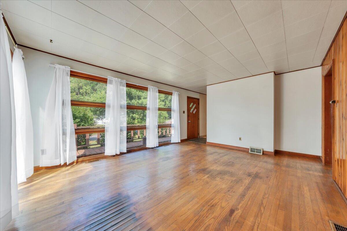 201 Long Avenue Covington, VA 24426 - Photo 8 of 43 a view of an empty room with wooden floor and a window