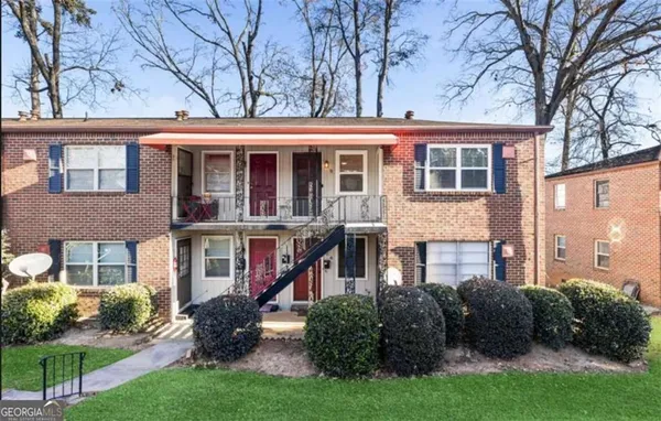 a front view of a building with a garden