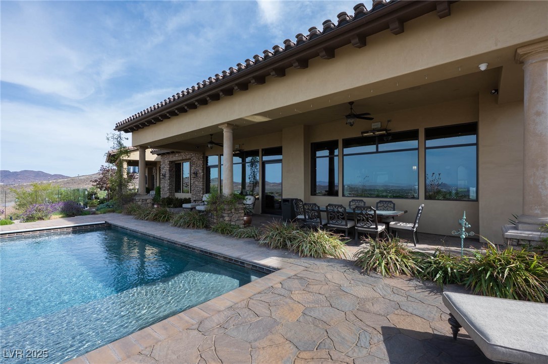 1123 Christian Road Henderson, NV 89002 - Photo 15 of 83 Outdoor pool featuring a patio, a ceiling fan, and a mountain view