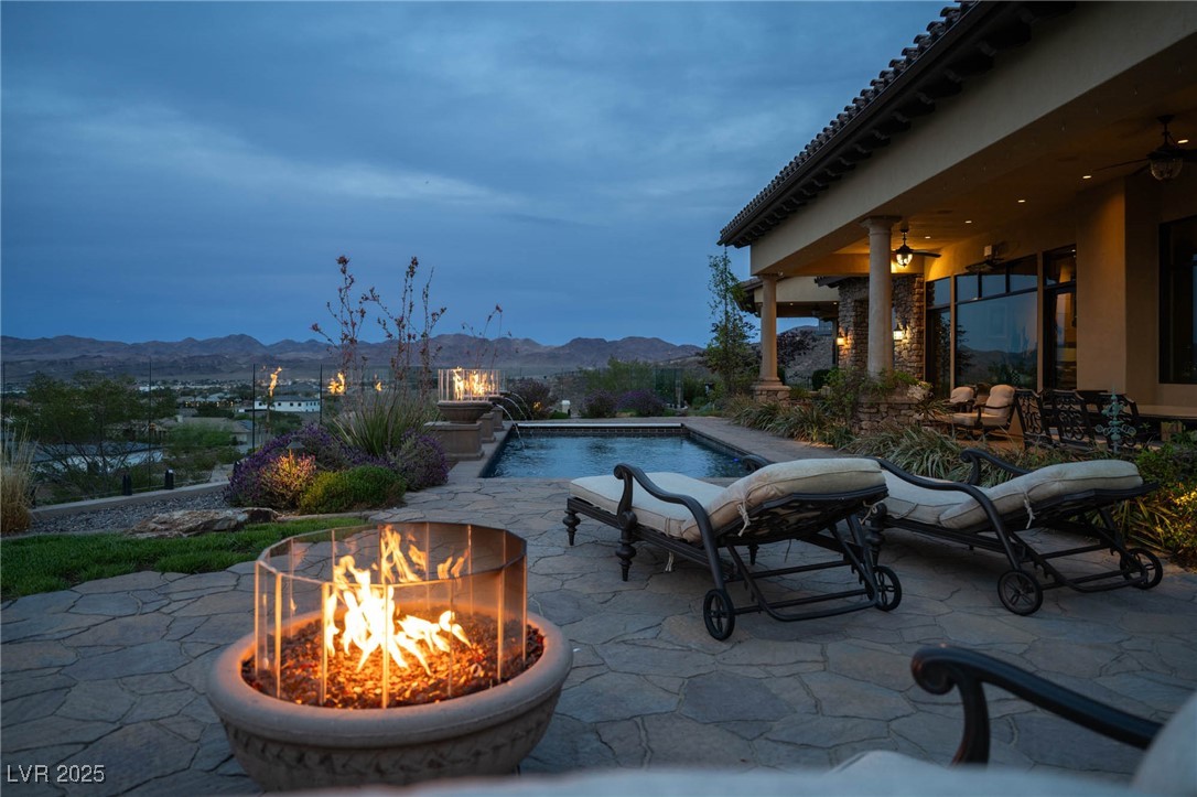 1123 Christian Road Henderson, NV 89002 - Photo 25 of 83 Outdoor pool featuring a mountain view, a fire pit, and a patio