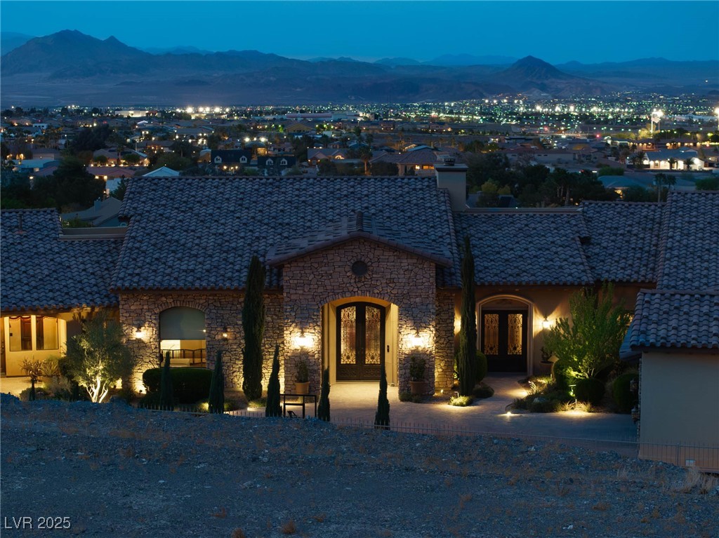 1123 Christian Road Henderson, NV 89002 - Photo 28 of 83 View of front of home with iron double doors, a mountain view, and stone siding