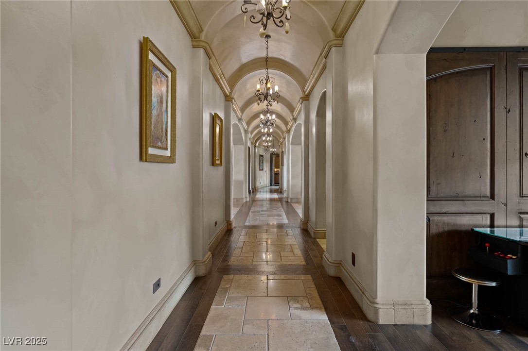 1123 Christian Road Henderson, NV 89002 - Photo 33 of 83 Dramatic hallway, arched ceiling, stone baseboards, ornamental molding, stone tile flooring,