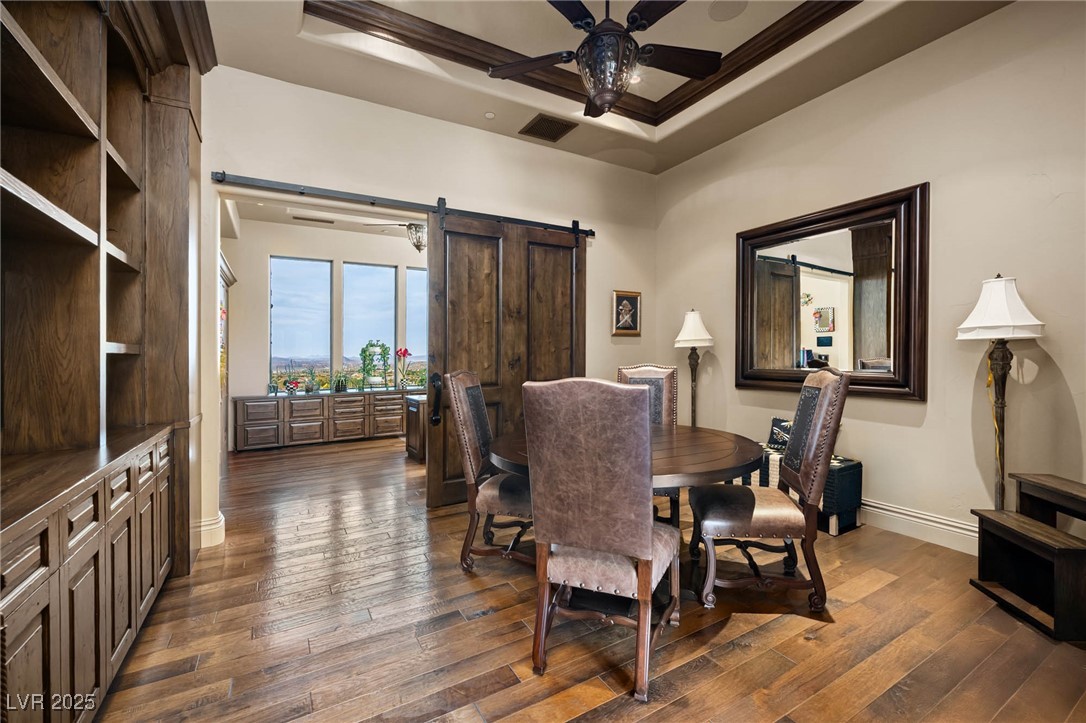 1123 Christian Road Henderson, NV 89002 - Photo 62 of 83 Conference room with ceiling fan, dark wood-type flooring, visible vents, a barn door, and baseboards