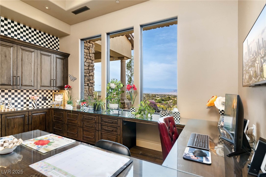 1123 Christian Road Henderson, NV 89002 - Photo 64 of 83 Office featuring visible vents, dark brown cabinets, recessed lighting, wood finished floors, and backsplash