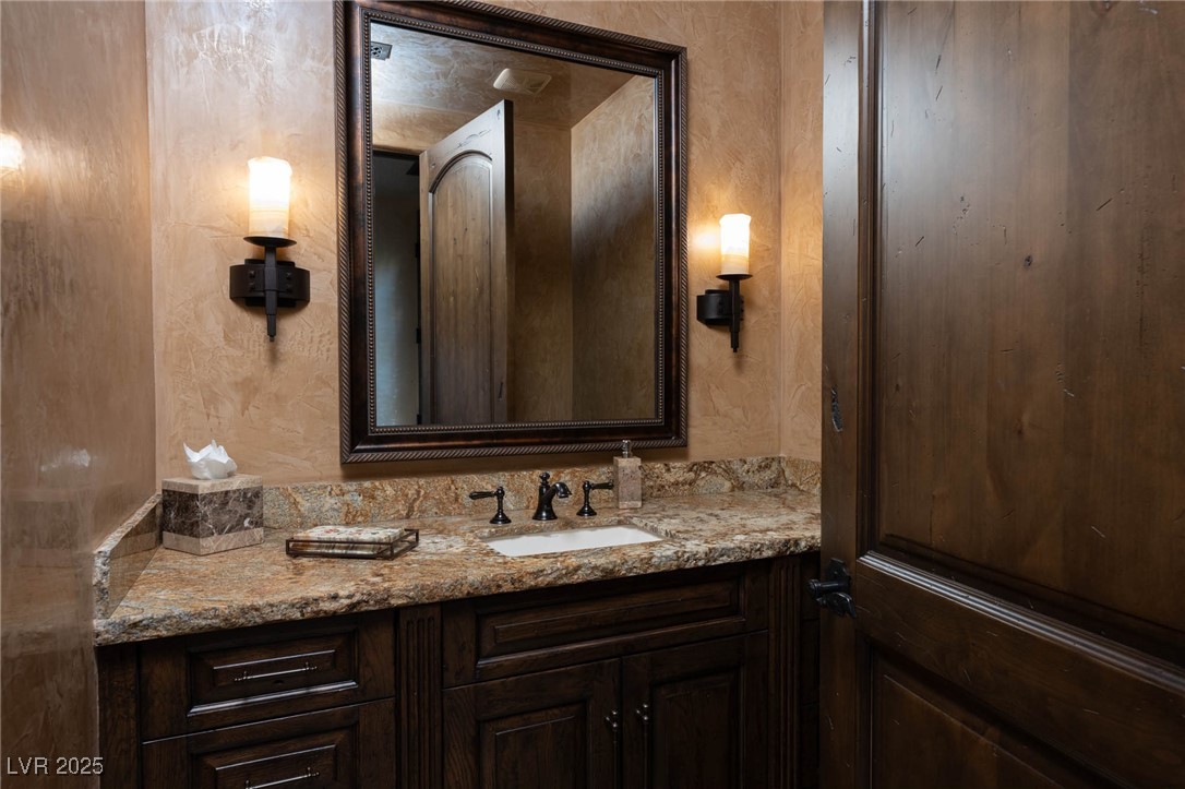 1123 Christian Road Henderson, NV 89002 - Photo 65 of 83 Hallway Bathroom featuring a designer plaster textured wall and vanity