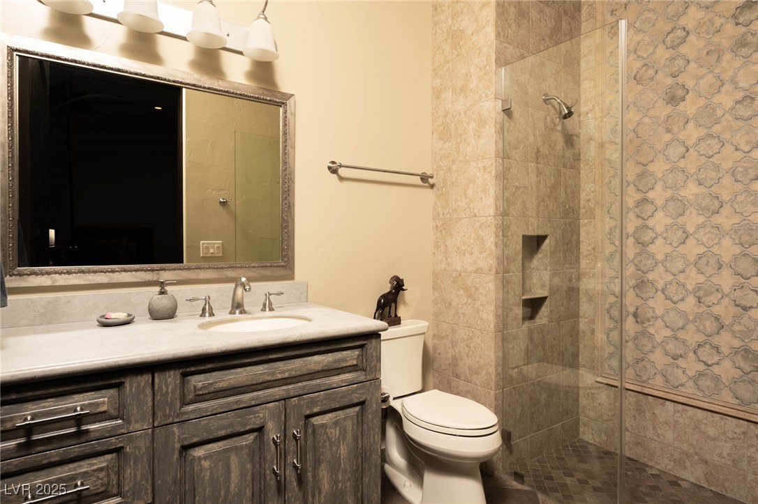 1123 Christian Road Henderson, NV 89002 - Photo 69 of 83 Attached bathroom featuring a shower stall, vanity, and toilet
