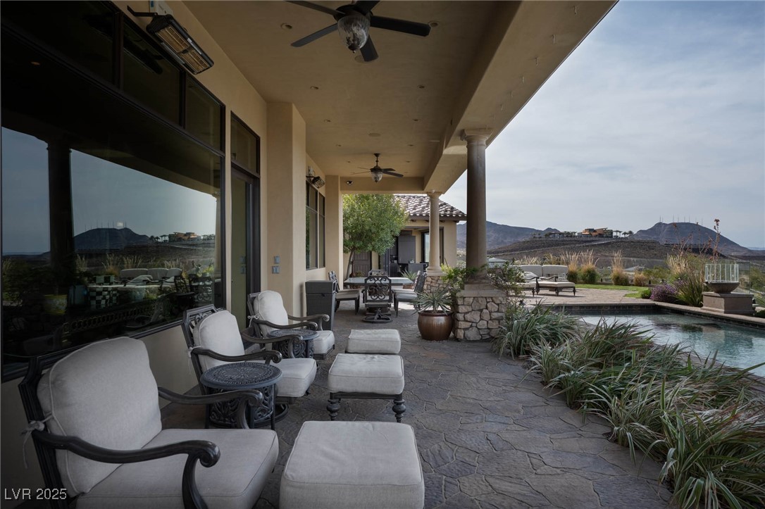 1123 Christian Road Henderson, NV 89002 - Photo 77 of 83 View of patio with outdoor dining area, a mountain view, and a ceiling fan