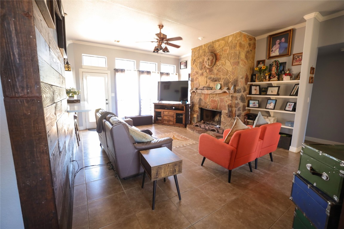 535 Upper Elgin River Road Elgin, TX 78621 - Photo 11 of 28 a living room with fireplace furniture and a flat screen tv