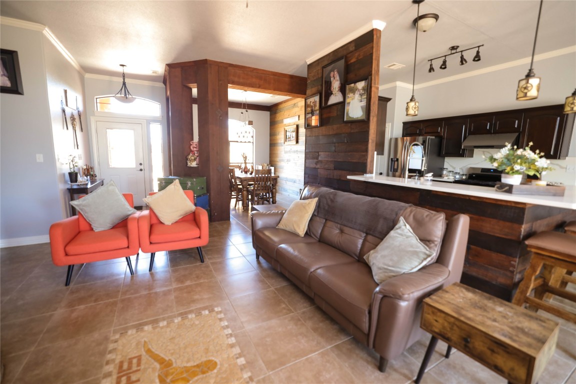 535 Upper Elgin River Road Elgin, TX 78621 - Photo 12 of 28 a living room with furniture a fireplace and a chandelier