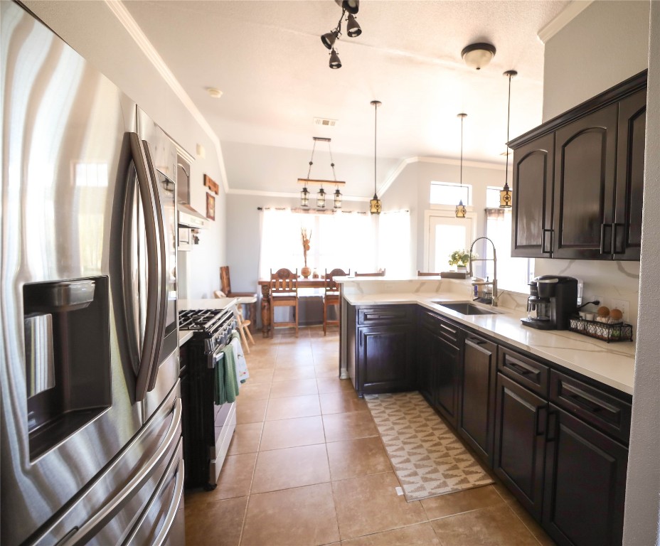 535 Upper Elgin River Road Elgin, TX 78621 - Photo 16 of 28 a kitchen with stainless steel appliances granite countertop a refrigerator a sink a stove and island