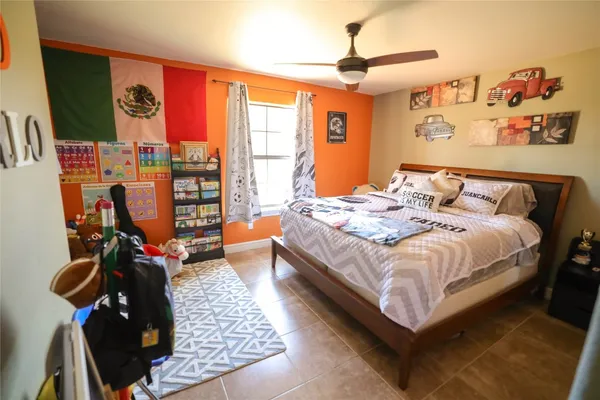 a bed sitting in a bedroom next to a window