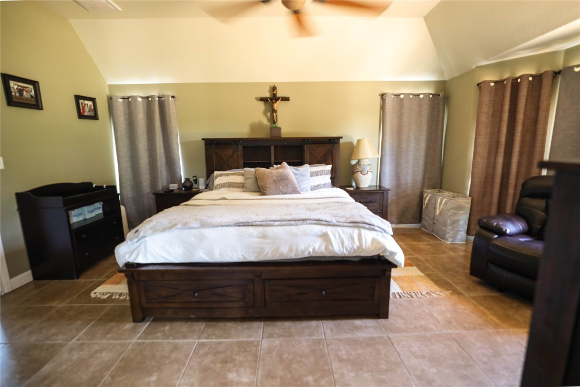 535 Upper Elgin River Road Elgin, TX 78621 - Photo 22 of 28 a bed sitting in a bedroom and a mirror