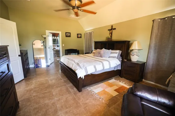 a bedroom with a bed and a mirror