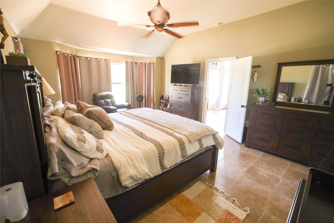 535 Upper Elgin River Road Elgin, TX 78621 - Photo 24 of 28 a bedroom with a bed dresser and a large window