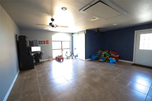 a view of a room with gaming equipment and windows