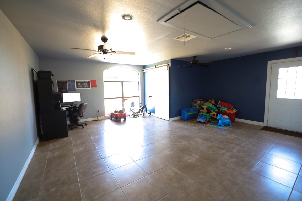 535 Upper Elgin River Road Elgin, TX 78621 - Photo 28 of 28 a view of a room with gaming equipment and windows