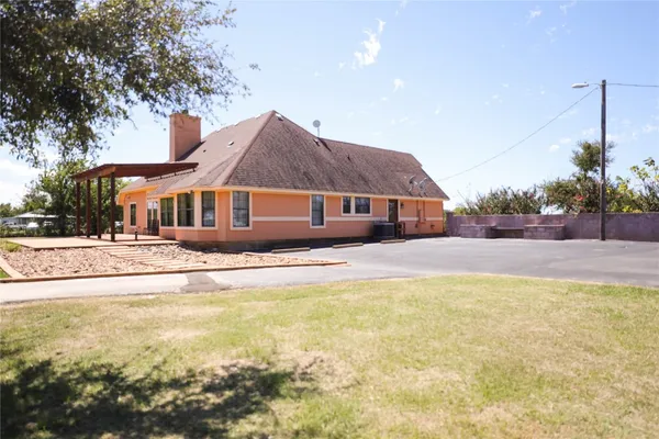 a view of house with yard and swimming pool
