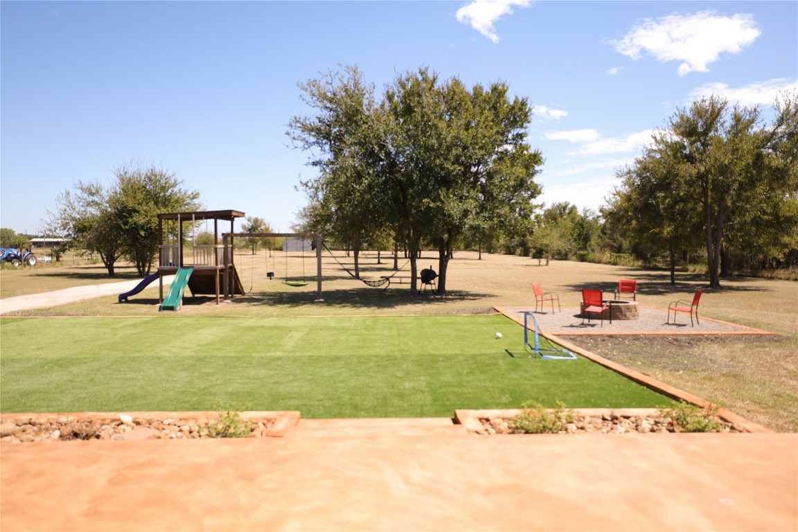 535 Upper Elgin River Road Elgin, TX 78621 - Photo 6 of 28 a view of a park with swings and slides