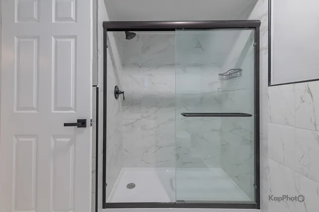 a bathroom with a glass shower door
