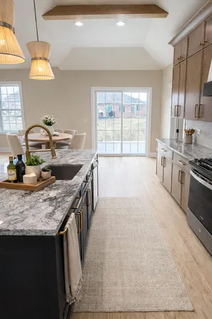 a kitchen with stainless steel appliances granite countertop a sink stove and cabinets