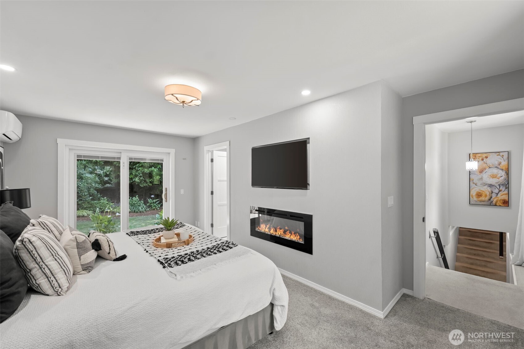 12170 Viewcrest Place Northeast Bainbridge Island, WA 98110 - Photo 15 of 37 a bedroom with a bed a television and a window