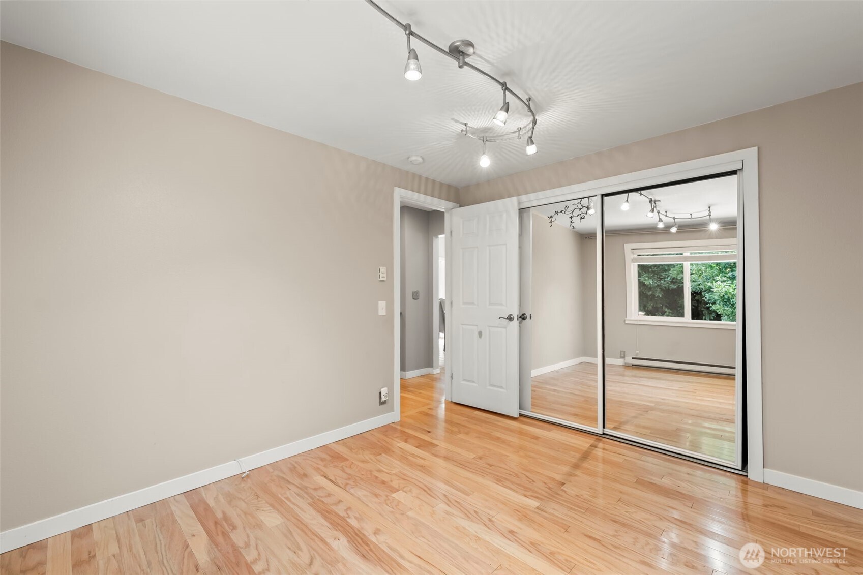 12170 Viewcrest Place Northeast Bainbridge Island, WA 98110 - Photo 19 of 37 a view of empty room with wooden floor