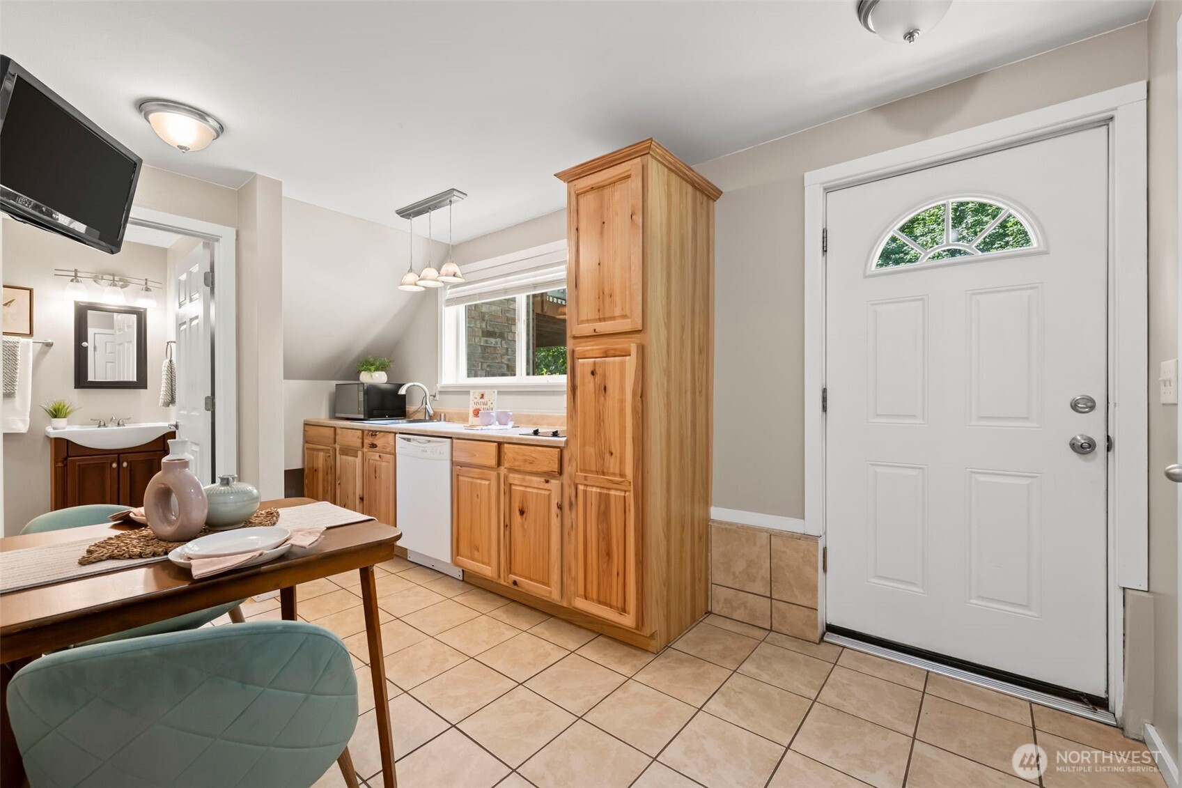 12170 Viewcrest Place Northeast Bainbridge Island, WA 98110 - Photo 26 of 37 a room with furniture a flat screen tv and kitchen view