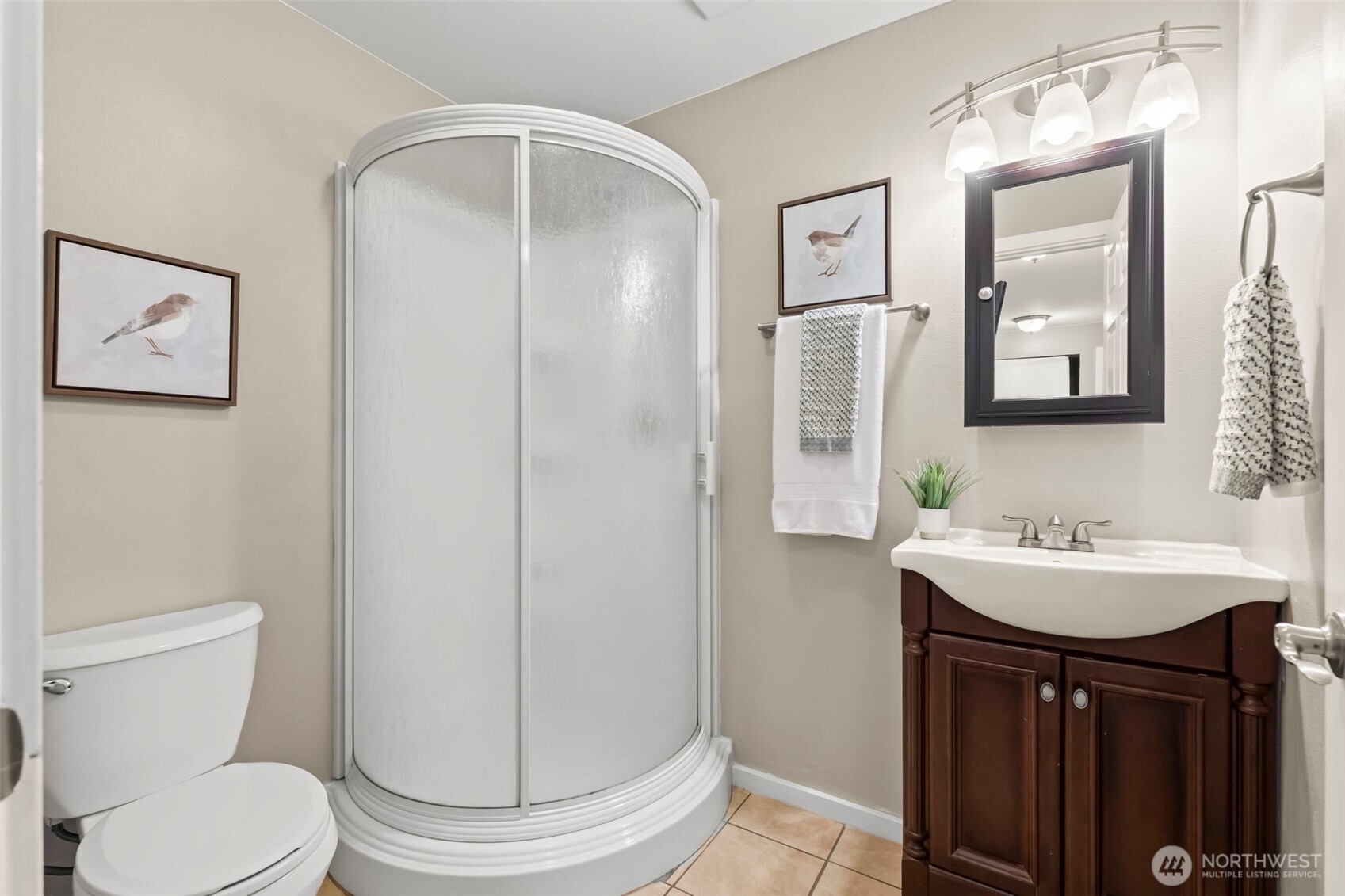 12170 Viewcrest Place Northeast Bainbridge Island, WA 98110 - Photo 29 of 37 a bathroom with a toilet a sink and mirror