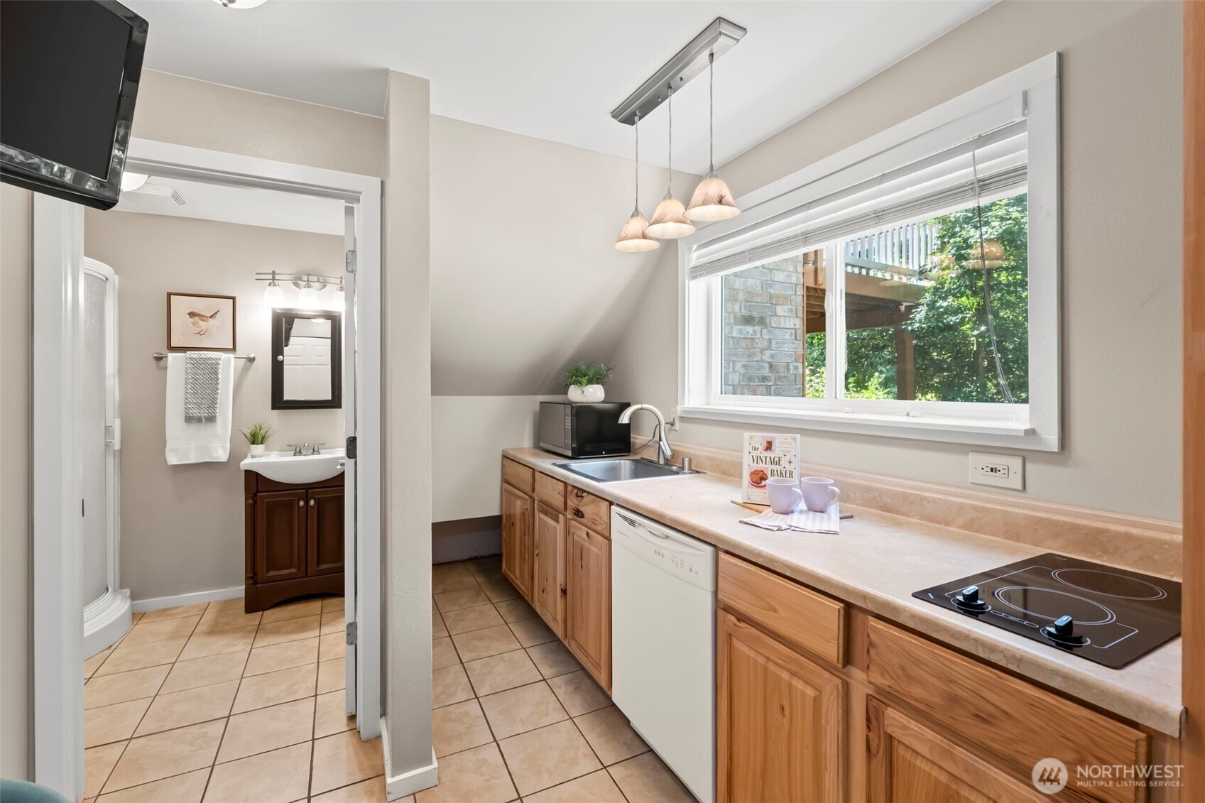 12170 Viewcrest Place Northeast Bainbridge Island, WA 98110 - Photo 30 of 37 a kitchen with a sink and refrigerator