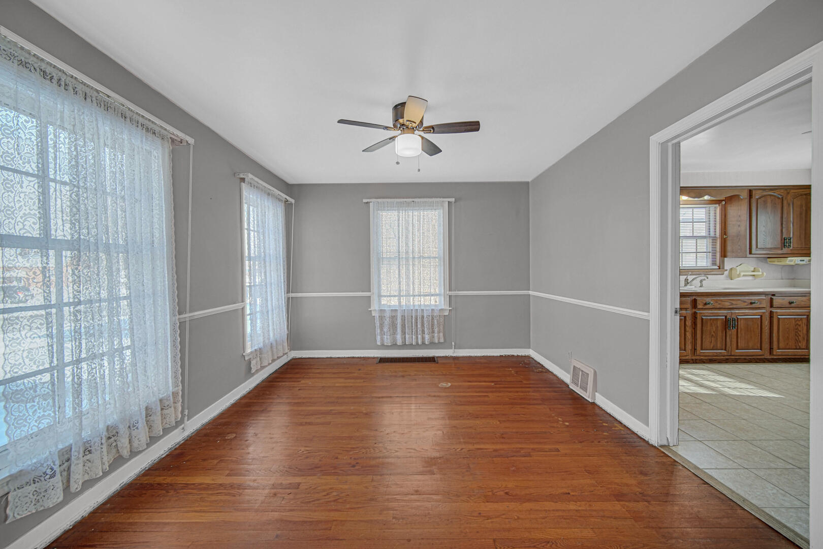 248 Adelaide Place Munster, IN 46321 - Photo 11 of 28 a view of a livingroom with a ceiling fan window and wooden floor