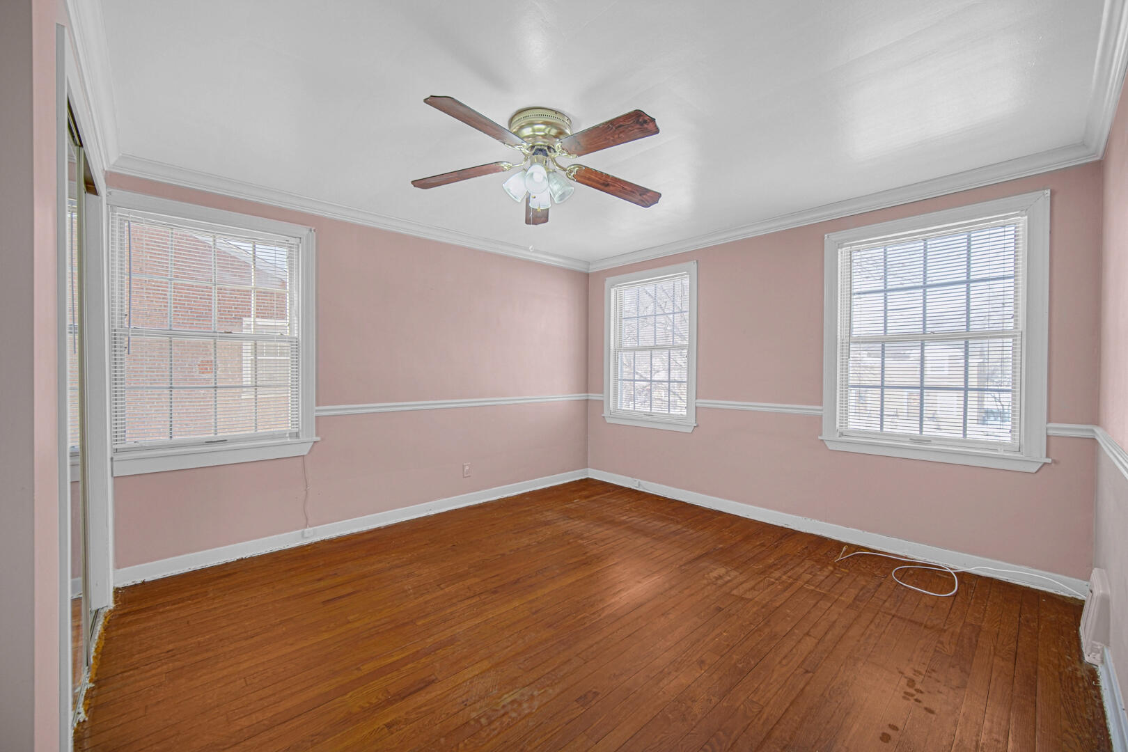 248 Adelaide Place Munster, IN 46321 - Photo 16 of 28 an empty room with wooden floor fan and windows