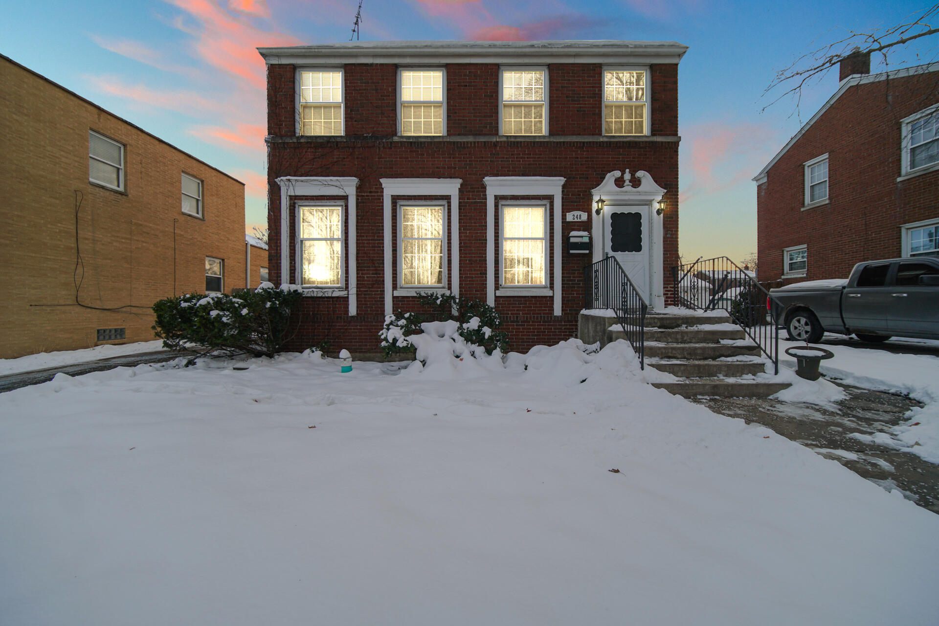 248 Adelaide Place Munster, IN 46321 - Photo 2 of 28 a view of a brick house with many windows